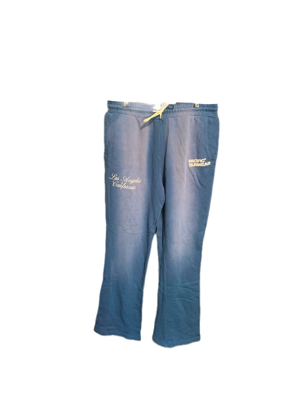 PacSun blue sweatpants with a yellow drawstring and embroidered text reading